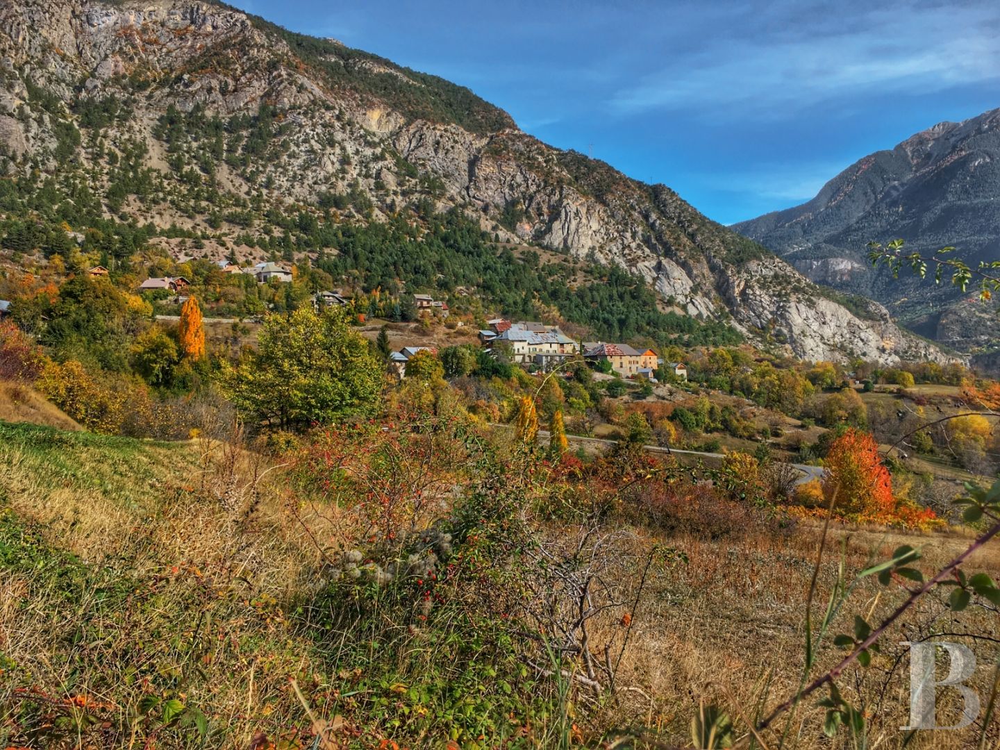 A former priory bathed in sunlight and surrounded by snowy mountain tops,  to the south of Briançon in the Hautes-Alpes - photo  n°1