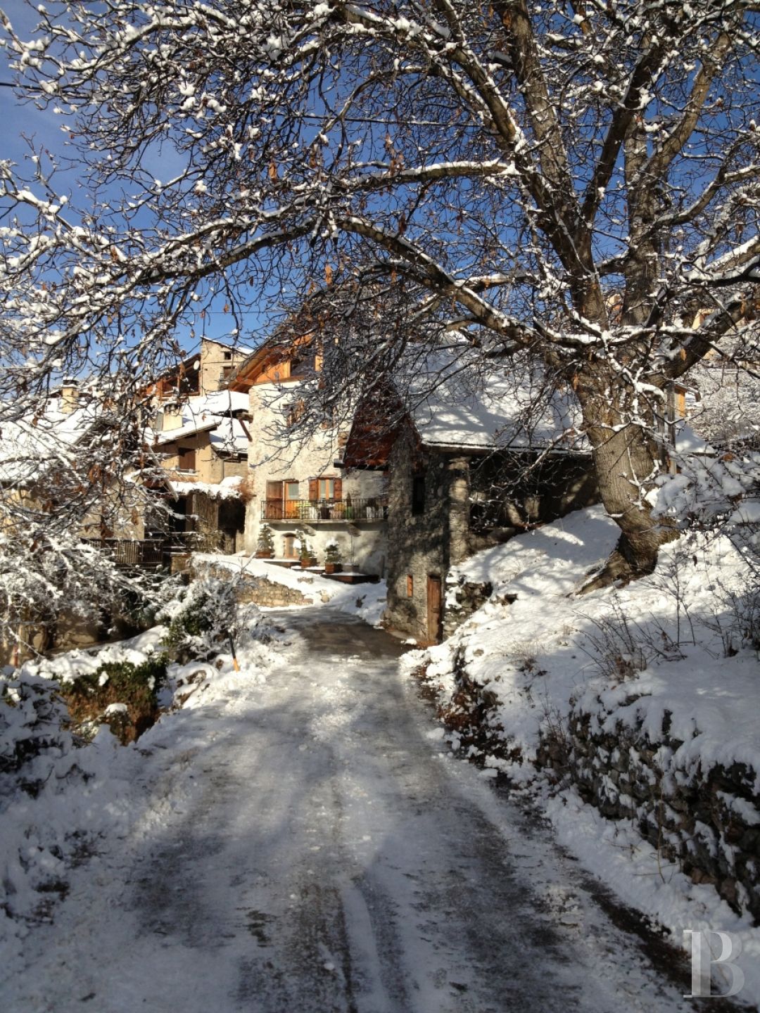 A former priory bathed in sunlight and surrounded by snowy mountain tops,  to the south of Briançon in the Hautes-Alpes - photo  n°3