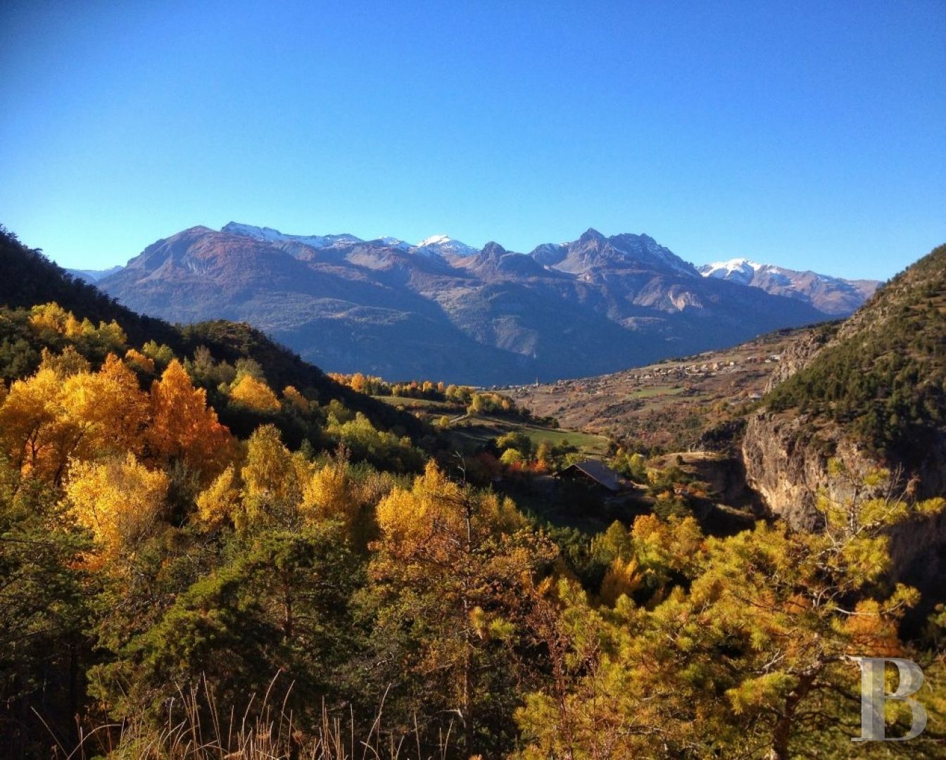 A former priory bathed in sunlight and surrounded by snowy mountain tops,  to the south of Briançon in the Hautes-Alpes - photo  n°6