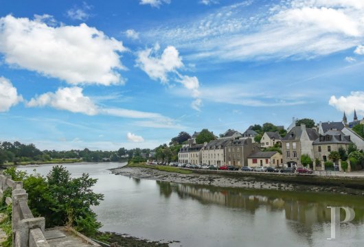 A 16th-century former posthouse to be renovated, listed as a historical monument with a terraced garden, nestled on a riverbank in a town in France’s Morbihan department