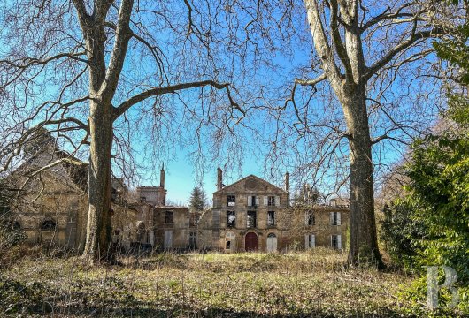burgundy - The vestiges of the 18th-century Chateau de Cussigny, a regional historical monument,  surrounded by its outbuildings and 7-hectare grounds along the banks of a river, near Beaune in Burgundy