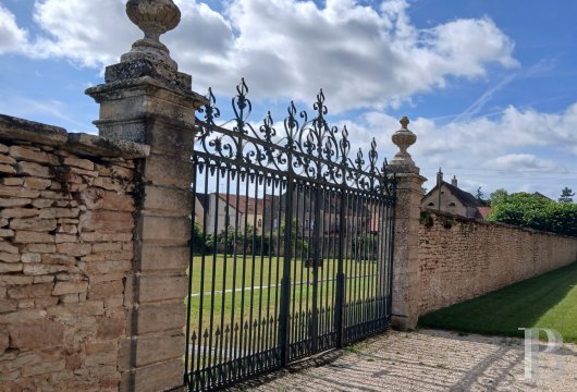 A listed chateau from the 14th and 18th centuries with a moat and 2.5 hectares  of grounds, nestled by the town of Beaune, Burgundy, and its vineyards 
